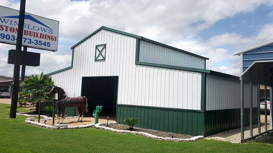 Texwin horse barn with covered side area and a horse outside